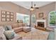 Open concept living room with hardwood floors, comfortable seating, and fireplace at 17 Brightwater Cv, Dallas, GA 30157
