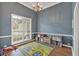 Charming play room with blue walls, hard wood floors, and bright natural light at 17 Brightwater Cv, Dallas, GA 30157
