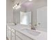 Primary bathroom featuring double sinks with modern fixtures, a large mirror, and white cabinets at 4531 Claiborne Ct, Duluth, GA 30096