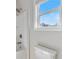 Bright bathroom with neutral paint colors, window with blinds, and shower and bath at 4531 Claiborne Ct, Duluth, GA 30096
