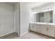 Bright bathroom with double vanity, large mirrors and neutral tile flooring at 4531 Claiborne Ct, Duluth, GA 30096