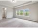 Spacious bedroom features tray ceilings, plush carpet and large windows for natural light at 4531 Claiborne Ct, Duluth, GA 30096