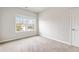 Cozy bedroom with carpet flooring and bright windows looking out to the neighborhood at 4531 Claiborne Ct, Duluth, GA 30096
