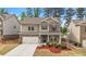 Charming two-story home with brick and siding exterior, landscaped yard, and a two-car garage at 4531 Claiborne Ct, Duluth, GA 30096