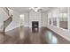 Spacious living room featuring a fireplace, hardwood floors, large windows, and a staircase at 4531 Claiborne Ct, Duluth, GA 30096