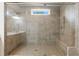The large glass enclosed shower features gray tile, built-in seat and shower niche at 4531 Claiborne Ct, Duluth, GA 30096