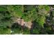 Aerial view showing home's placement on secluded lot with tree coverage and proximity to amenities at 6881 Homestead Rd, Rex, GA 30273
