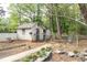View of the backyard with an exterior shed featuring a chain-link fence and some greenery at 6881 Homestead Rd, Rex, GA 30273