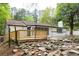 Image of the backyard with a new wooden deck and the exterior of the home with a white brick chimney at 6881 Homestead Rd, Rex, GA 30273