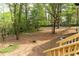View of the backyard and landscaping from a high vantage point on the wooden stairs and deck at 6881 Homestead Rd, Rex, GA 30273
