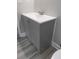 Modern bathroom vanity with gray cabinetry, white countertop, and wood-look flooring at 6881 Homestead Rd, Rex, GA 30273