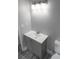 Bathroom features a modern vanity with a sleek countertop and a contemporary lighting fixture at 6881 Homestead Rd, Rex, GA 30273