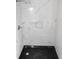 Shower with black base and white marble-patterned tile walls, with built-in niche at 6881 Homestead Rd, Rex, GA 30273