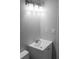 Bathroom features a modern vanity with a sleek countertop and a contemporary lighting fixture at 6881 Homestead Rd, Rex, GA 30273