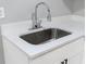 Modern bathroom sink with stainless steel faucet and white countertop at 6881 Homestead Rd, Rex, GA 30273