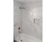 Modern bathroom features stylish marbled tiling, a sleek shower head, and an alcove for bath products at 6881 Homestead Rd, Rex, GA 30273