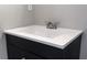 Modern bathroom vanity with dark cabinetry and white countertop at 6881 Homestead Rd, Rex, GA 30273