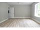 The bedroom has hardwood floors, grey walls, white trim and baseboards, and an open door at 6881 Homestead Rd, Rex, GA 30273