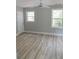 Bedroom showcasing hardwood floors, a ceiling fan, two windows, and closet at 6881 Homestead Rd, Rex, GA 30273