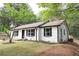 Beautifully landscaped one-story home featuring a new back deck and renovated exterior paint at 6881 Homestead Rd, Rex, GA 30273
