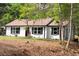 Charming one-story home on a lush lot featuring updated exterior, windows, and landscaping at 6881 Homestead Rd, Rex, GA 30273