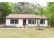 Charming one-story home featuring freshly painted exterior, new front door, and freshly landscaped yard at 6881 Homestead Rd, Rex, GA 30273
