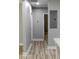 Hallway shows the durable, light wood flooring and neutral paint throughout the home at 6881 Homestead Rd, Rex, GA 30273