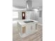 This kitchen features a center island with storage, a cooktop, and a modern range hood at 6881 Homestead Rd, Rex, GA 30273