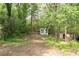 Wooded land with some existing structures offering a secluded and natural setting at 6881 Homestead Rd, Rex, GA 30273