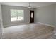Bright living room with hardwood floors, a window, and an eye-catching front door at 6881 Homestead Rd, Rex, GA 30273