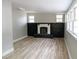 Spacious living room featuring hardwood floors and a black brick fireplace at 6881 Homestead Rd, Rex, GA 30273