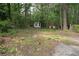 Ground-level view of wooded lot with shed at 6881 Homestead Rd, Rex, GA 30273