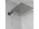 A modern square shower head is featured against a backdrop of marbled tile at 6881 Homestead Rd, Rex, GA 30273