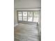 Bright sunroom with light wood floors and many windows, perfect for enjoying natural light indoors at 6881 Homestead Rd, Rex, GA 30273