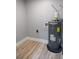 Water heater, utility hookups, and neutral paint make up this well-maintained utility room at 6881 Homestead Rd, Rex, GA 30273