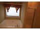Bathroom featuring a jetted tub, glass shower and window with decorative valance at 115 Catlyn Ct, Riverdale, GA 30296