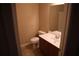 Half bathroom includes a dark wood vanity and a well-lit mirror at 115 Catlyn Ct, Riverdale, GA 30296