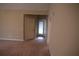 Spacious living room area with carpeted floors leading to an outdoor entry at 115 Catlyn Ct, Riverdale, GA 30296