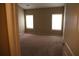 Main bedroom featuring carpet and large windows that provide natural light at 115 Catlyn Ct, Riverdale, GA 30296