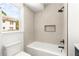 Modern bathroom featuring a shower with a glass door, white tile, and matte black fixtures at 197 Holcomb Ferry Rd, Roswell, GA 30076