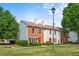 Charming townhouse with brick and siding, featuring a well-manicured lawn and bright red doors at 197 Holcomb Ferry Rd, Roswell, GA 30076