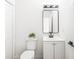Bright half bath features a stylish mirror and sleek fixtures at 197 Holcomb Ferry Rd, Roswell, GA 30076