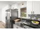 This kitchen features stainless steel appliances, granite countertops, and a stainless steel farmhouse sink at 197 Holcomb Ferry Rd, Roswell, GA 30076