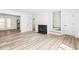 Open concept living room with wood floors, fireplace, and modern accents at 197 Holcomb Ferry Rd, Roswell, GA 30076