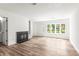 Light-filled living room boasts wood floors, a fireplace, and a large window at 197 Holcomb Ferry Rd, Roswell, GA 30076