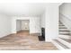 Bright living room features wood floors, a modern fireplace, and stairway at 197 Holcomb Ferry Rd, Roswell, GA 30076