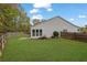 Spacious, green backyard featuring a wood fence and the home's exterior with large windows at 3401 Ravensworth Trce, Kennesaw, GA 30144