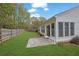 Nice backyard featuring a well-maintained lawn, stone patio, and views of the sunroom's windows at 3401 Ravensworth Trce, Kennesaw, GA 30144
