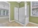 Bright bathroom features a glass-enclosed shower with tiled floor and backyard view at 3401 Ravensworth Trce, Kennesaw, GA 30144