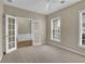 A naturally lit room featuring French doors, carpet, and three windows at 3401 Ravensworth Trce, Kennesaw, GA 30144